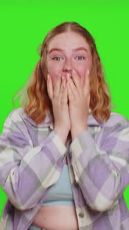 Enthusiastic woman celebrates success against green screen