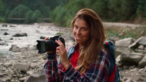 Happy Woman Taking Photos by Mountain Stream