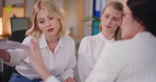 Three Young Adults Meeting in Modern Office