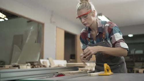 Carpenter is working at workshop.