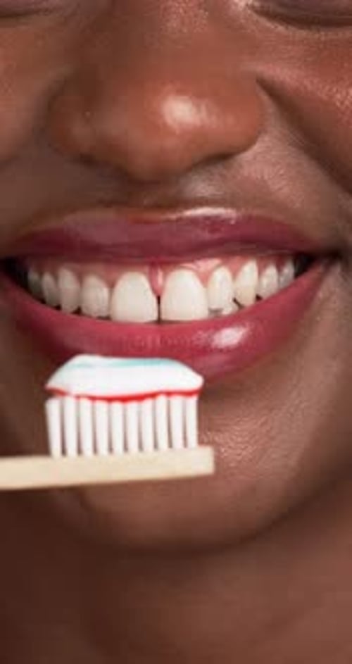 Woman Smiling, Toothbrush with Toothpaste in Close Up
