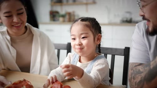 Happy Family Eating Pizza at Home Together