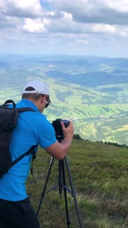 A Photographer is Capturing a Stunning Scenic Landscape View From a Breathtaking Mountain Peak