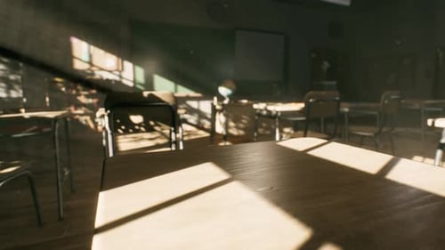 View to Classroom with Tables and Small Blackboard and Grungy Walls