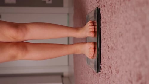 Girl On Scales Measure Weight Close Up. Child Legs Step Bathroom Scale. Fitness Diet Young Person