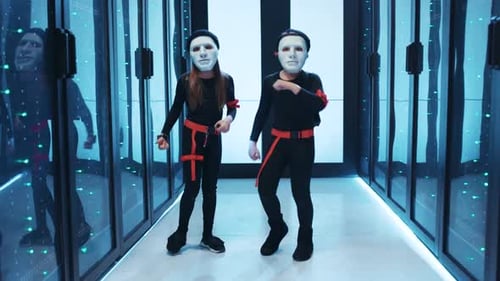 Masked Figures Dance in a Futuristic Server Room