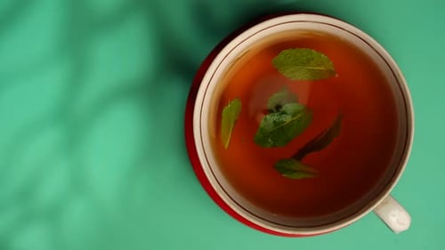 Cup of Tea with Fresh Mint Leaves Top View
