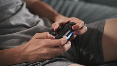 Close Up Hands of Caucasian Young Boy Using Wireless Controller
