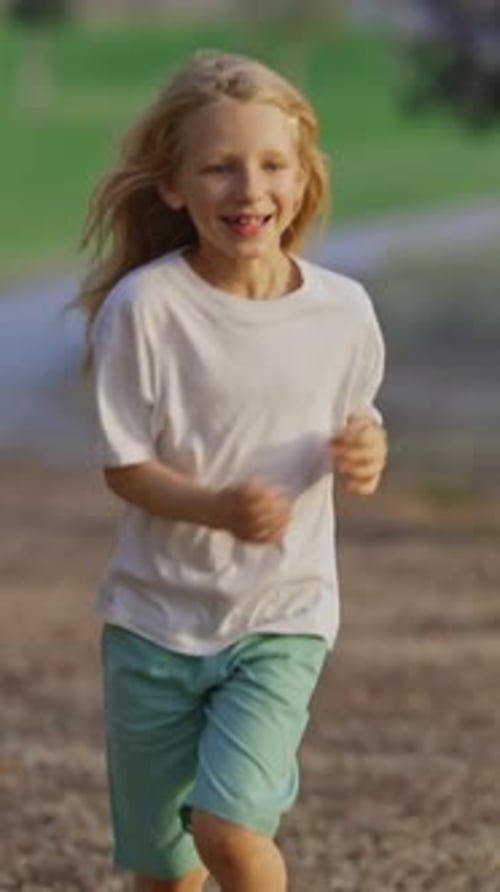 Young Boy Running in a Park with Family