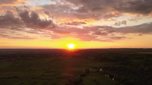 Dramatic Sunset Over Rural Green Fields Aerial View