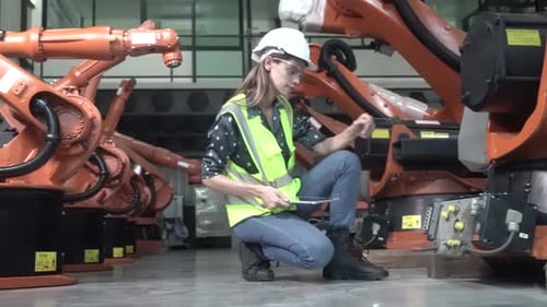 Engineer woman working inside robotic factory - Tech industry concept