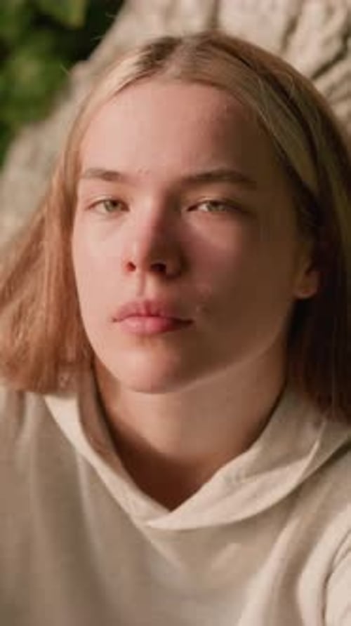 Young Adult with Blonde Hair Looking at Camera