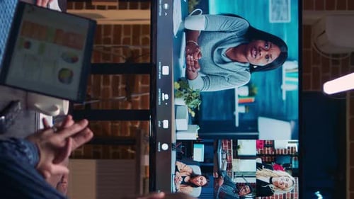 Online Video Conference Displayed on Monitor in Office