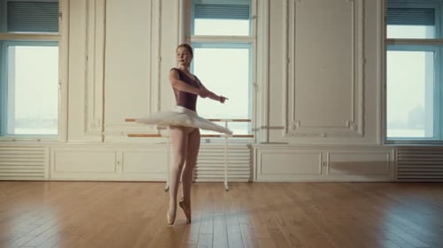 Red Haired Ballerina Posing in Bright Studio