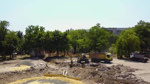 Excavator Loading Truck at Construction Site