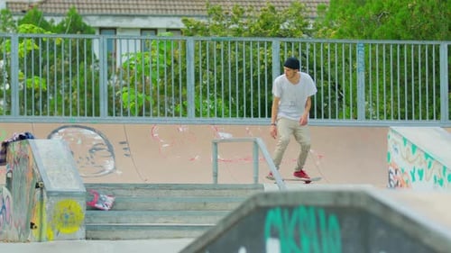 Young Adult Skateboarding at Urban Graffiti Skatepark