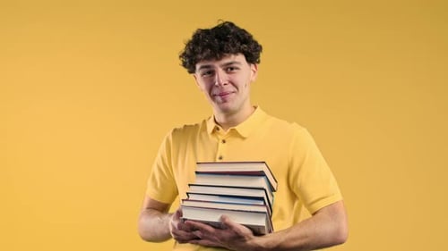 Jewish Clever Student Man Holds Stack of University Books From College Library on Yellow Background