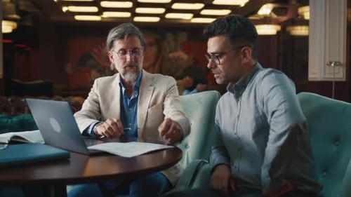 Businessman Signing Contract with Man
