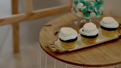 Delicious Cupcakes with Frosting on Golden Tray