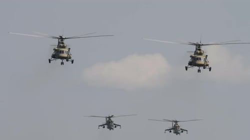 Military Helicopters Fly in Formation