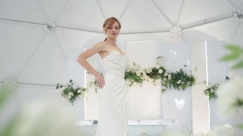 The Model Poses Against the Background of the Banquet Hall