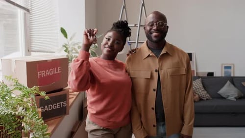 Portrait of Happy Couple with Keys in New House
