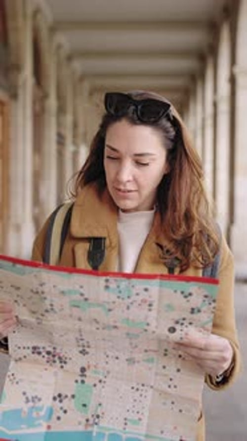 Woman Tourist Looks at Map in City