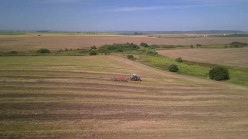 Tractor working on the field doing tillage with cultivator