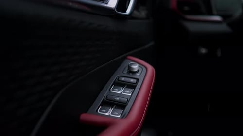 Closeup View of the Power Window Control Panel in a Luxury Car with Black and Red Interior