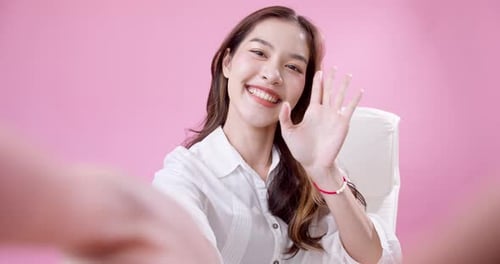 Cheerful Young Woman Waving on Video Call