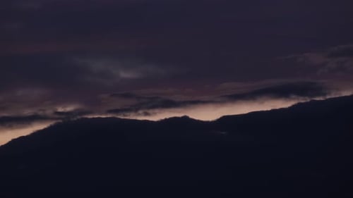 Dark Clouds Drifting Slowly at Sunset