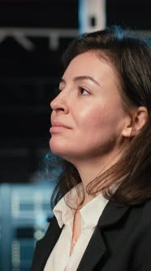 Vertical Video Engineer Walking in Data Center Looking at Industrial Systems Virtualization