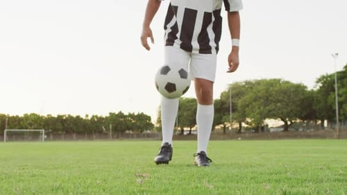 Video of biracial football player on field with ball