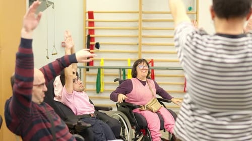 Adults Exercise Arms in Therapy Session at Hospital