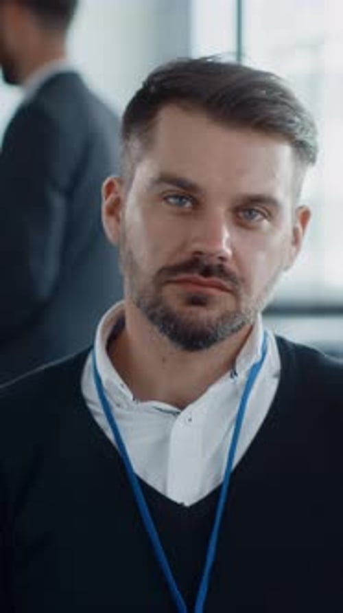 Professional Male in an Office Setting Displaying a Thoughtful and Attentive Expression