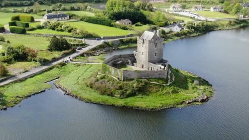 aerial shot in orbit over the medieval castle of Dunguaire and the waters that surround it, in Irela