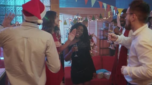 Friends Celebrate Christmas with Champagne and Holiday Cheer