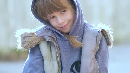 Child in Hoodie Looking at Camera