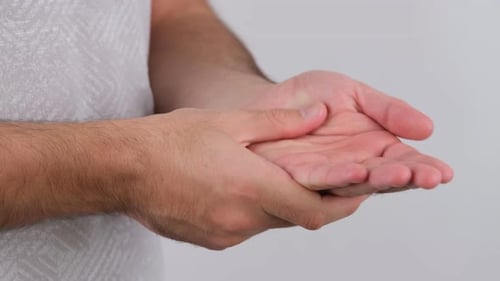 Man Rubbing Hand in a Close Up Shot