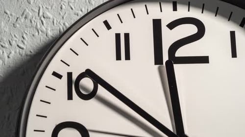 Timelapse of a wall clock. The time is twelve o'clock.