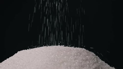 Measure Full Teaspoon of White Granulated Sugar From a Pile of Sugar Slow Motion