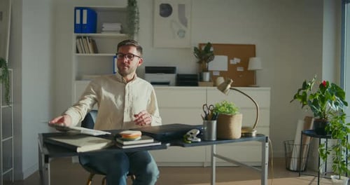 Man Working at Laptop in Bright Home Office