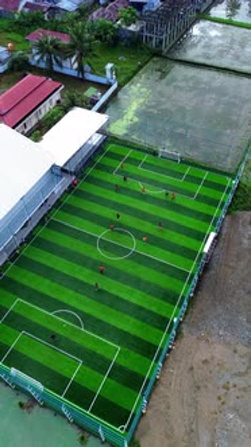 Vertical Drone Footage of mini football match, soccer. MiniFootball field and Footballers from drone