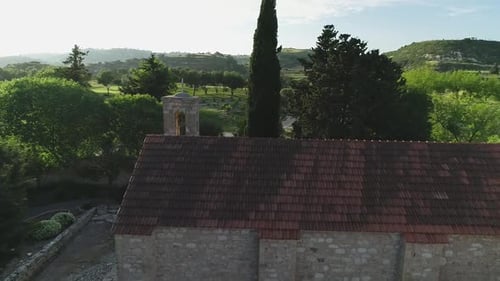 Aerial View Of Historic Stone Church In The Heart Of Lush Green Landscape