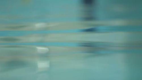 Abstract water background with beautiful light reflections in swimming pool waves