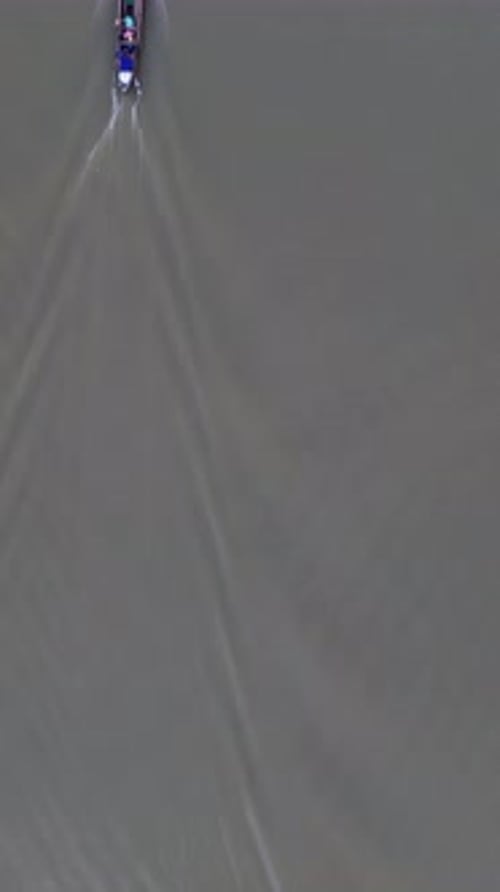 Vertical Drone Footage of Small Fishing Boats Floating on the River in the Forest