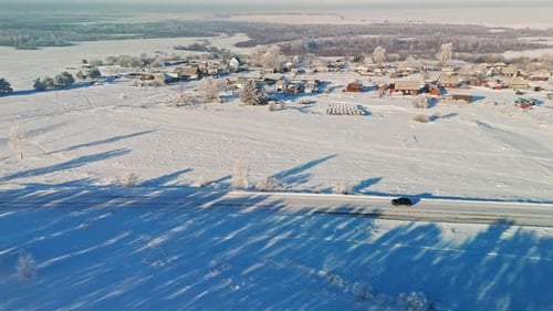 Scenic Winter Landscape with Snowcovered Village and Road Seen From Above