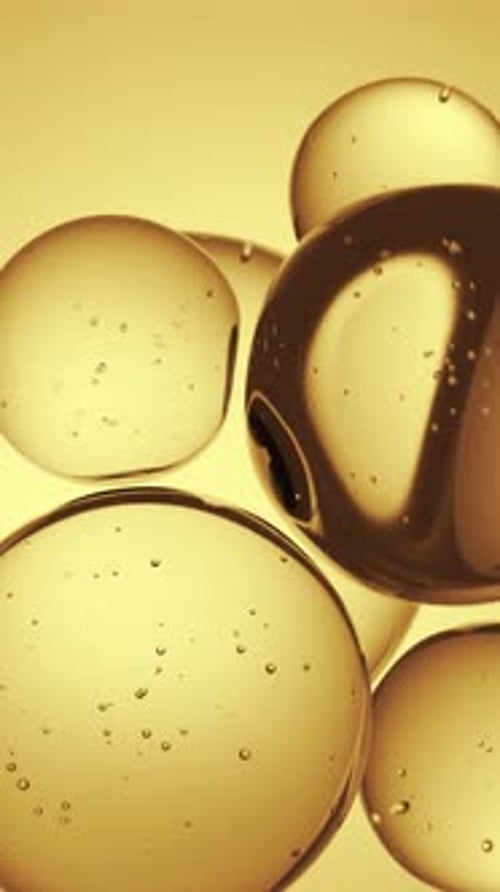 Floating Golden Fluid Orbs Macro Abstract Background