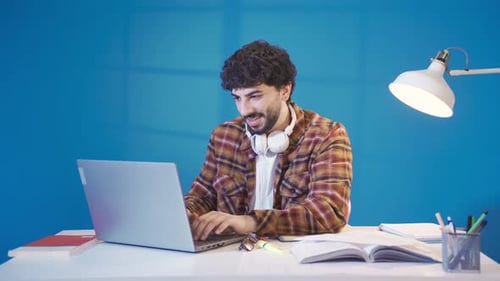 Man Working on Laptop at Desk