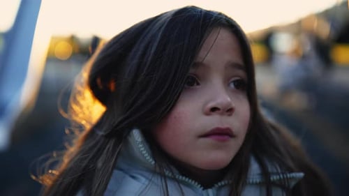 Sad Little girl with contemplative gaze. Introspective 8 year old child close-up face stands